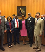 Genesis E. Draper, center, takes photo with Harris County Commissioners Court on Tuesday shortly after she was appointed to succeed the late County Court at Law No. 12 Judge Cassandra Hollemon.