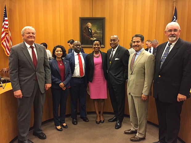 Genesis E. Draper, center, takes photo with Harris County Commissioners Court on Tuesday shortly after she was appointed to succeed the late County Court at Law No. 12 Judge Cassandra Hollemon.