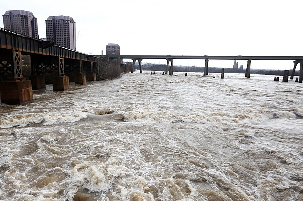 The still swollen James River is an awesome sight as it rushes Wednesday through Richmond’s Downtown near the Federal Reserve Bank and Riverfront Towers. Still, the water was beginning to subside and had fallen below the 12-foot flood stage in this area by the afternoon, according to the U.S. Geological Survey, which keeps close track of the flow. On Tuesday, the river had risen to more than 16 feet as it passed through the area, fueled by weekend rains in the western part of the state. The city, which is protected by a floodwall in much of its Downtown, did not report any significant disruption or damage from the high water. (Regina H. Boone/Richmond Free Press)