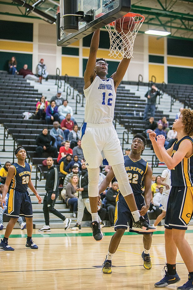 John Marshall High School senior Aubrey Merritt goes up for the score during the Justices’ 100-62 victory over Culpeper County High School on Feb. 22 in the regional final.