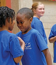 No laughing matter-
It looks like a stare down. But youngsters in the Greater Richmond Children’s Choir were performing “No Laugh Race” on Saturday, a song interspersed with a challenge requiring two people to stare at each other without laughing. The first one to laugh loses. The choir also engaged members of the audience in the performance. (Sandra Sellars/Richmond Free Press)
