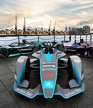 Formula E cars are pictured by the river Thames