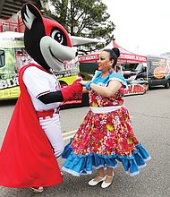 Nutzy’s ‘Block Party’:
Nutzy, one of two mascots for the Richmond Flying Squirrels baseball team, shows off some of his salsa moves with Carmen Santiago of Petersburg last Saturday during Nutzy’s Block Party 2019. The annual event at The Diamond, complete with music, food, information and giveaways, was the opening day for individual ticket sales for the Flying Squirrels’ upcoming season. Opening day at the Richmond ballpark on the Boulevard is Thursday, April 4, when the Squirrels play the Hartford Yard Goats. (Regina H. Boone/Richmond Free Press)