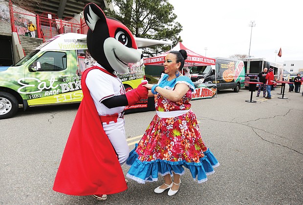 Nutzy’s ‘Block Party’:
Nutzy, one of two mascots for the Richmond Flying Squirrels baseball team, shows off some of his salsa moves with Carmen Santiago of Petersburg last Saturday during Nutzy’s Block Party 2019. The annual event at The Diamond, complete with music, food, information and giveaways, was the opening day for individual ticket sales for the Flying Squirrels’ upcoming season. Opening day at the Richmond ballpark on the Boulevard is Thursday, April 4, when the Squirrels play the Hartford Yard Goats. (Regina H. Boone/Richmond Free Press)