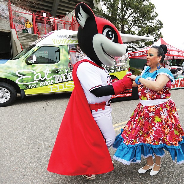 Nutzy’s ‘Block Party’:
Nutzy, one of two mascots for the Richmond Flying Squirrels baseball team, shows off some of his salsa moves with Carmen Santiago of Petersburg last Saturday during Nutzy’s Block Party 2019. The annual event at The Diamond, complete with music, food, information and giveaways, was the opening day for individual ticket sales for the Flying Squirrels’ upcoming season. Opening day at the Richmond ballpark on the Boulevard is Thursday, April 4, when the Squirrels play the Hartford Yard Goats. (Regina H. Boone/Richmond Free Press)