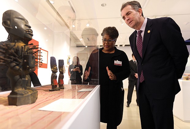 ‘Unbound 2019: Truth & Reconciliation’:
In one of his first public appearances since the blackface scandal, Gov. Ralph S. Northam attends the opening of “Unbound 2019: Truth & Reconciliation” on Feb. 28, at The Gallery at Main Street Station. This is the first part of a yearlong exhibition launched by the Richmond Slave Trail Commission to tell the stories of Africans in the Americas before 1619 through the present day. Mieko M. Timmons explains some of the exhibition pieces to Gov. Northam. Located on the first floor, the exhibition is open to the public without charge 8 a.m. to 5 p.m. daily at the station, 1500 E. Main St. Under Gov. McDonnell’s administration, the state put up $11 million for various historical projects related to memorializing the enslaved in Virginia, including the Lumpkin’s Jail site and a related museum in Shockoe Bottom and funds for the improvement of the Richmond Slave Trail. (Regina H. Boone/Richmond Free Press)