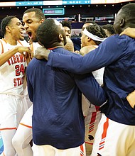 Virginia State University team members celebrate after winning the CIAA title last Saturday in Charlotte, N.C. The Trojans defeated Shaw University 77-66 in the final.