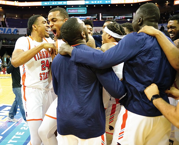 Virginia State University team members celebrate after winning the CIAA title last Saturday in Charlotte, N.C. The Trojans defeated Shaw University 77-66 in the final.