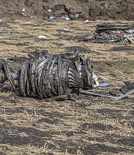 Airplane parts lie on the ground at the scene of the Ethiopian Airlines crash on Monday.