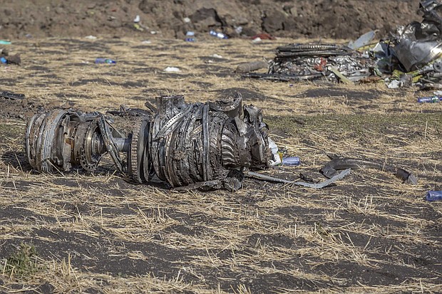 Airplane parts lie on the ground at the scene of the Ethiopian Airlines crash on Monday.