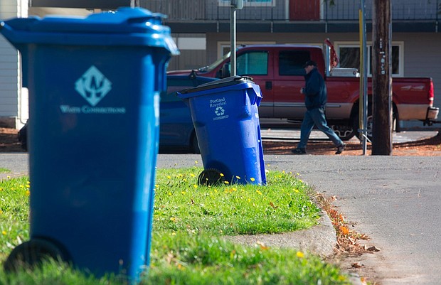 Blue recycling bins are seen on a residential street in Portland, Oregon. Coca-Cola will use learnings from its Atlanta program to help scale its recycling efforts.