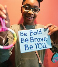 Business sense: Lauren Ferrell, 13, shows off inspirational handcrafted items she designed for her business, “Simply Inspired by Lauren.” She and dozens of other young entrepreneurs were selling their wares Saturday at the Richmond Children’s Business Fair. (Regina H. Boone/Richmond Free Press)