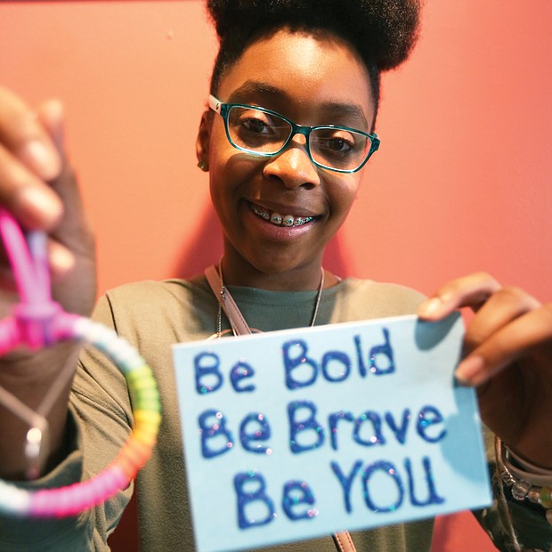 Business sense: Lauren Ferrell, 13, shows off inspirational handcrafted items she designed for her business, “Simply Inspired by Lauren.” She and dozens of other young entrepreneurs were selling their wares Saturday at the Richmond Children’s Business Fair. (Regina H. Boone/Richmond Free Press)