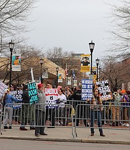 A small group of protesters from Westboro Baptist Church chant and hold signs denigrating the LGBTQ community as a larger group of counterprotesters on the Virginia Commonwealth University campus plays kazoos to drown out their message.