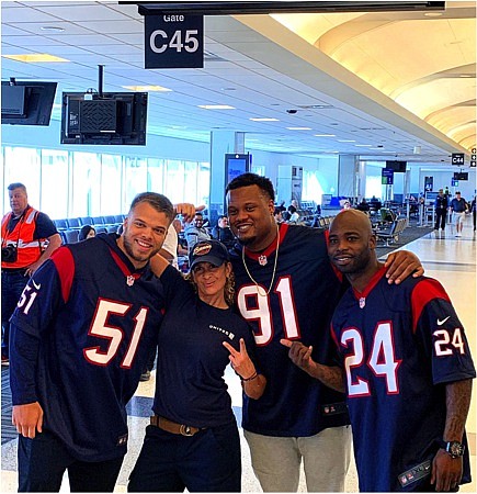 Texans players surprise United Airlines customers and employees in the terminal at George Bush International Airport