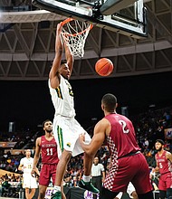 Norfolk State University forward Alex Long goes up for a dunk during the final at the Norfolk Scope.