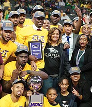 The North Carolina Central University Eagles show off their MEAC Tournament trophy after defeating Norfolk State University 50-47 last Saturday.