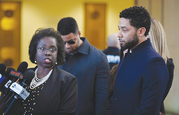 Jussie Smollett, right, stands beside his attorney, Patricia Brown Holmes, at a press conference in Chicago after prosecutors on Tuesday dropped felony charges accusing him of faking a racist, anti-gay attack on himself. The “Empire” star agreed to do community service and let the city keep his $10,000 bail exchange for the deal.