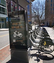 Electric bikes power up at a docking station.