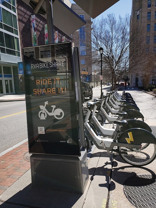 Electric bikes power up at a docking station.