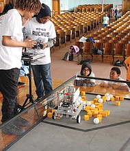 Robotic ruckus: Students from Richmond’s Lucille Brown Middle School compete in the “Rover Ruckus FIRST Tech Challenge” held at Richmond Community High School last Friday. Teams of 12 students from the city’s middle schools, Franklin Military Academy and Community High designed, built and programmed a competition robot from a kit without instructions. Then, using remote controls, the students had 2½ minutes to maneuver their robots to pick up as many different shaped objects as possible and place them in a container. The robot placing the most objects in the container during the time limit was declared the winner. Results of the competition: Community High, 1st place; Franklin Academy, 2nd place; and Elkhardt-Thompson Middle School, 3rd place. (Ronald E. Carrington/Richmond Free Press)