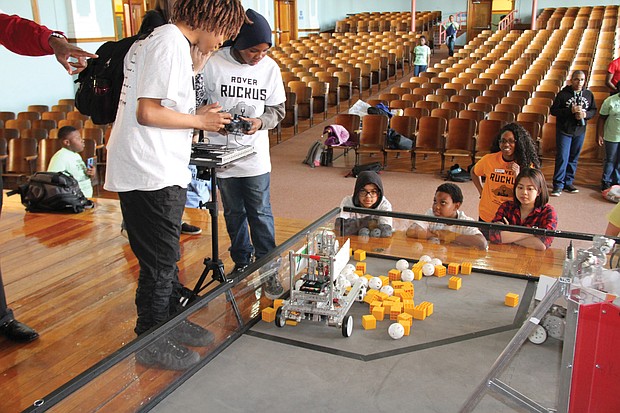 Robotic ruckus: Students from Richmond’s Lucille Brown Middle School compete in the “Rover Ruckus FIRST Tech Challenge” held at Richmond Community High School last Friday. Teams of 12 students from the city’s middle schools, Franklin Military Academy and Community High designed, built and programmed a competition robot from a kit without instructions. Then, using remote controls, the students had 2½ minutes to maneuver their robots to pick up as many different shaped objects as possible and place them in a container. The robot placing the most objects in the container during the time limit was declared the winner. Results of the competition: Community High, 1st place; Franklin Academy, 2nd place; and Elkhardt-Thompson Middle School, 3rd place. (Ronald E. Carrington/Richmond Free Press)