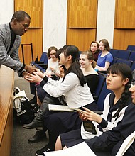 Japan ‘Sister City’ recognition: Richmond Mayor Levar M. Stoney greets several students from Saitama, Japan, last week during their visit to City Council chambers to recognize the 20th anniversary of Saitama’s partnership with Richmond in the Sister City program. The high school students and two teachers from Urawa Municipal High School spent a week in the Richmond area through the scholastic exchange program. The students visited the Virginia Museum of Fine Arts and Maymont, where there was a welcome ceremony in the Japanese Gardens. Saitama and four other cities in Mali, Namibia, China and England have Sister City relationships with Richmond. (Regina H. Boone/Richmond Free Press)