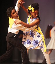 Tango togetherness: D’andre Morris, left, and Aaliya Thornhill showcase their tango moves to impress judges at a ballroom dance competition March 28 at Huguenot High School. The two fifth-graders from Overby-Sheppard Elementary were among the young people who participated in the event that Dancing Classrooms of Greater Richmond hosted. The nonprofit organization, which promotes ballroom dancing in city schools as a way to instill discipline, courtesy, teamwork and other values, provided the schoolchildren with 10 weeks of instruction before the event. (Regina H. Boone/Richmond Free Press)