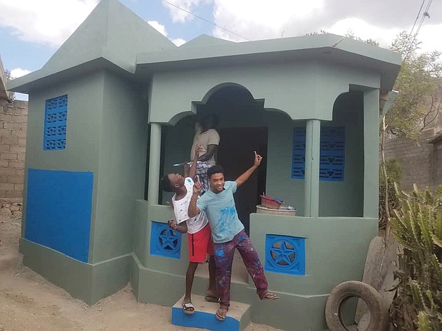 Youths celebrate a new home that Kenneth Barney and his Grace and Mercy Foundation built in Pignon, Haiti.