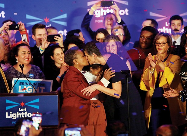 Chicago Mayor-elect Lori Lightfoot, left, kisses her wife, Amy Eshlemen, during her victory celebration Tuesday night after defeating challenger Toni Preckwinkle to become the first African-American woman and openly gay mayor of the city.