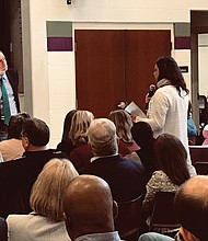 U.S. Sen. Mark Warner, left, listens as a community member speaks at Monday’s town hall-style meeting about food deserts in Richmond and the impact a lack of fresh and healthy foods has in low-income neighborhoods.