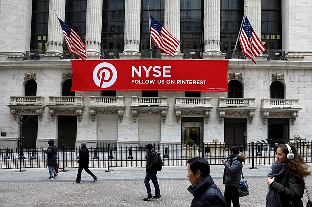 A Pinterest banner hangs on the facade of the New York Stock Exchange during the morning rush in February 2018. Pinterest is expected to go public later this month.