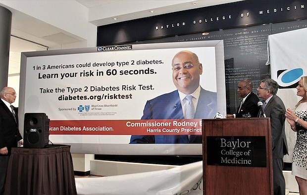 Dr. Paul Klotman and Melissa Edwards, executive director of Central South Texas American Diabetes Association, unveil a mock billboard that promotes the ADA’s type 2 diabetes risk test on Wednesday at a news conference.