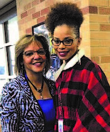 Congresswoman Robin Kelly (left) with Golden Apple Award recipient Catherine Ross-Cook, who teaches English literature and composition at the school.