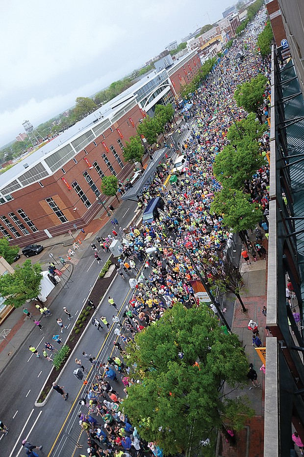 More than 25,000 runners and walkers turned out last Saturday for the annual Monument Avenue 10K. Right, runners begin the course in waves from the starting line at Broad Street near Harrison Street.