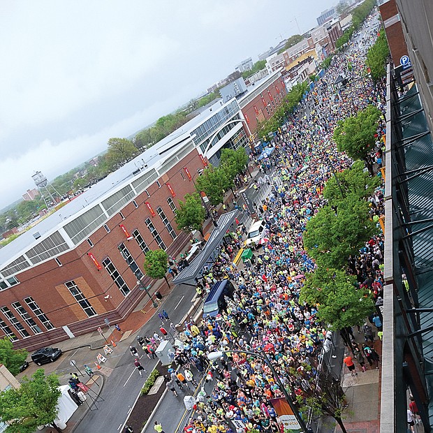 More than 25,000 runners and walkers turned out last Saturday for the annual Monument Avenue 10K. Right, runners begin the course in waves from the starting line at Broad Street near Harrison Street.