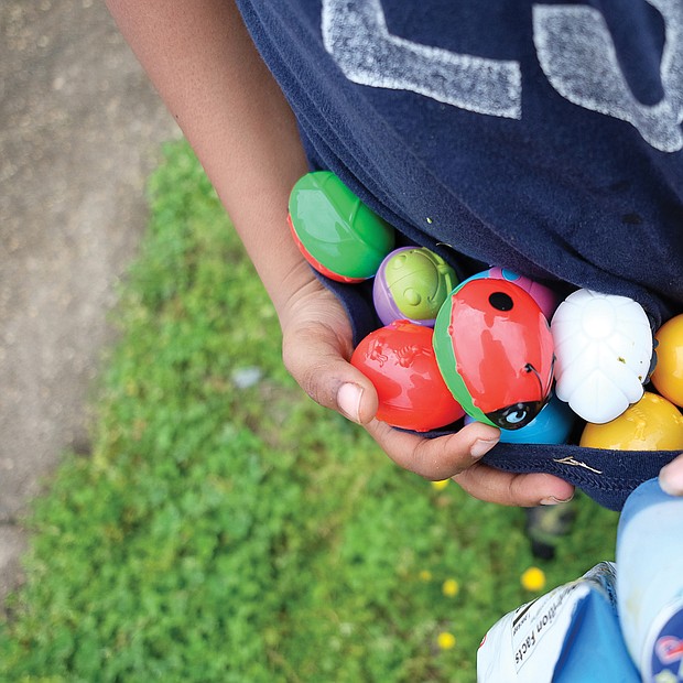 Egg-citing! Marcus Ellis, shows off the colorful collection of eggs he found last Saturday at the 7th Annual Easter Egg Hunt & Celebration at Blackwell Community Center in South Side. The free event was sponsored by Putting Communities Together Inc. (Sandra Sellars/Richmond Free Press)