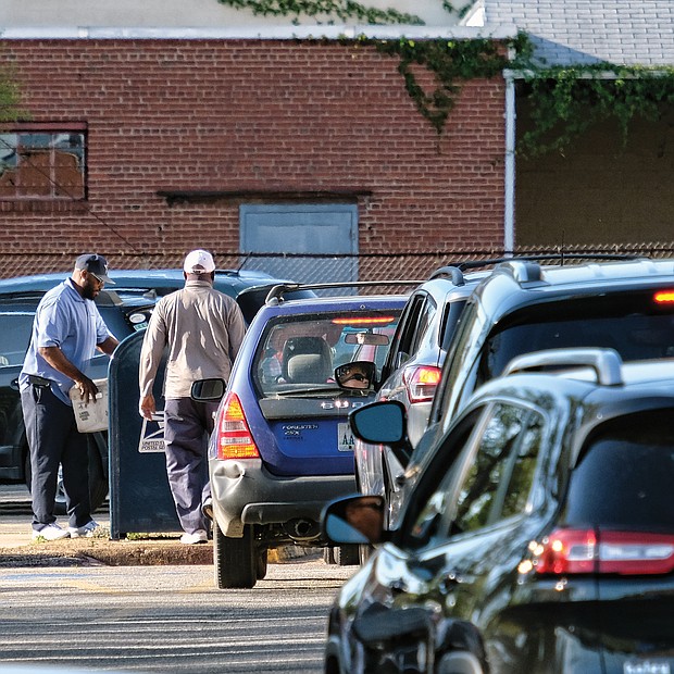 A line of motorists hurry to drop their 2018 federal income tax paperwork in the mail Monday by the tax filing deadline. The anxious drivers, photographed here about 6 p.m. Monday at the Main Post Office on Brook Road, were trying to ensure their envelopes received an April 15 postmark to avoid being hit with a penalty for missing the deadline. (Sandra Sellars/Richmond Free Press)