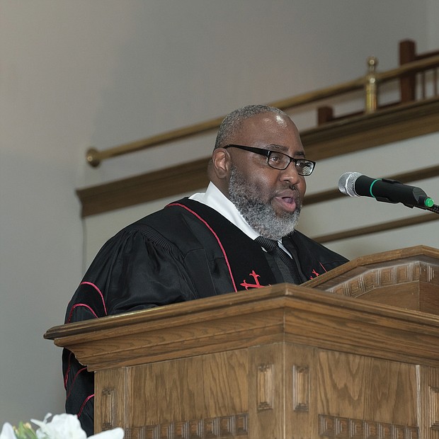 Dr. William Eric Jackson Sr. speaks from the pulpit Sunday at Fourth Baptist Church in Church Hill following his installation as the ninth pastor of the historic church that traces its beginnings to 1859. Visiting ministers and church deacons participate in a “laying of hands” ceremony with Dr. Jackson, seated, to cap the ceremony. (Ava Reaves)