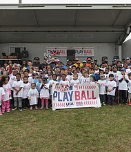 The Metropolitan Junior Baseball League joined with Major League Baseball, the Richmond Flying Squirrels and the City of Richmond to host “PLAY BALL,” a free event to interest youngsters ages 5 to 13 in baseball and softball. Hundreds of youths turned out April 6 for the event at Hotchkiss Field on Brookland Park Boulevard in North Side.
The Richmond Flying Squirrels and the City of Richmond, co-hosted “PLAY BALL,” a kid-focused event at Hotchkiss Field on Saturday, April 6. David James, right, vice president of baseball and softball development with MLB, encourages the youngsters to participate. The skill development session included stations to practice hitting home runs, running bases and bat and ball games. Participants received bats and balls, T-shirts and wristbands. (Ava Reaves)