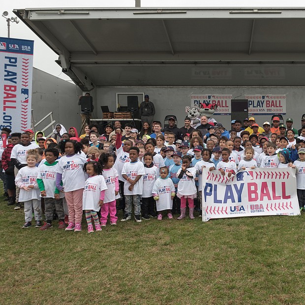 The Metropolitan Junior Baseball League joined with Major League Baseball, the Richmond Flying Squirrels and the City of Richmond to host “PLAY BALL,” a free event to interest youngsters ages 5 to 13 in baseball and softball. Hundreds of youths turned out April 6 for the event at Hotchkiss Field on Brookland Park Boulevard in North Side.
The Richmond Flying Squirrels and the City of Richmond, co-hosted “PLAY BALL,” a kid-focused event at Hotchkiss Field on Saturday, April 6. David James, right, vice president of baseball and softball development with MLB, encourages the youngsters to participate. The skill development session included stations to practice hitting home runs, running bases and bat and ball games. Participants received bats and balls, T-shirts and wristbands. (Ava Reaves)