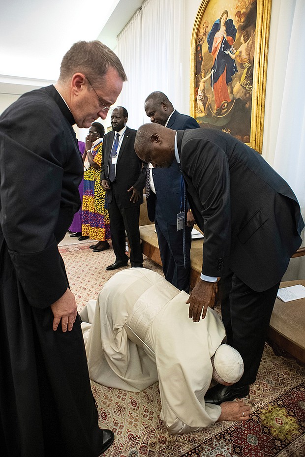 Pope Francis kneels to kiss the feet of South Sudan’s First Vice President Taban Deng Gai on April 11 at the close of a two-day spiritual retreat at the Vatican designed to bring unity to the African nation’s opposing factions.
