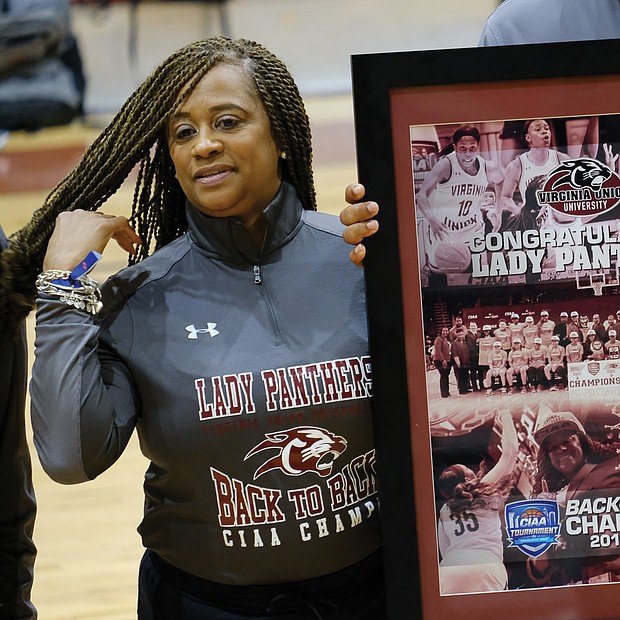 VUU Athletic Jamboree
Virginia Union University Lady Panthers Coach AnnMarie Gilbert and her basketball team members receive a congratulatory poster for winning back-to-back CIAA Tournament championships in 2018 and 2019. The recognition came last Saturday during the university’s annual Athletic Jamboree that included a double-header for the VUU softball team and the Panthers football team’s annual spring football game. Right, former longtime VUU football Coach Willard Bailey greets people from the bleachers. (Sandra Sellars/Richmond Free Press)
