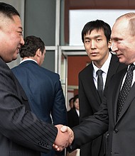 Russian President Vladimir Putin shakes hands with North Korean leader Kim Jong Un following their talks in Vladivostok on Thursday.