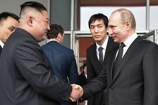 Russian President Vladimir Putin shakes hands with North Korean leader Kim Jong Un following their talks in Vladivostok on Thursday.