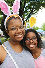 Thousands of people, including the Easter Bunny, stroll along Monument Avenue for what may be the final edition of Easter on Parade. Ogechi Mbagwu, 21, and her sister, Nasreen Mbagwu, 11, of Damascus, Md., show off the rabbit ears they donned for the Monument Avenue event.