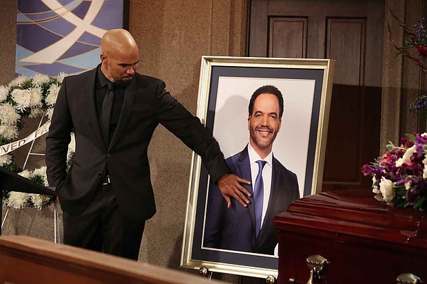 Shemar Moore looks at photo of Kristof St. John