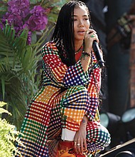 Performer Jhené Aiko plays to the  audience.