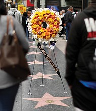 A memorial wreath stands on John Singleton’s star on the Hollywood Walk of Fame in Los Angeles. The 51-year-old director died Monday, April 29, 2019, after suffering several strokes.