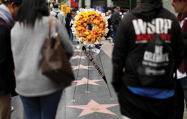 A memorial wreath stands on John Singleton’s star on the Hollywood Walk of Fame in Los Angeles. The 51-year-old director died Monday, April 29, 2019, after suffering several strokes.